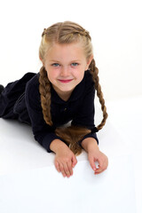 Wall Mural - Adorable little girl posing on a white cube.