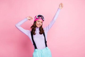 Wall Mural - Photo of cute adorable lady snowboarder wear purple pullover headwear mask glasses having rest rising fists isolated pink color background