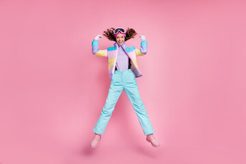 Wall Mural - Full length profile of adorable funky lady snowboarder wear colorful coat eyewear jumping isolated pink color background