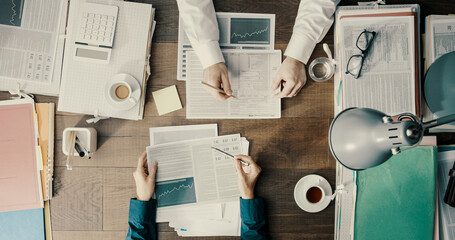 Wall Mural - Business people working together and checking financial charts