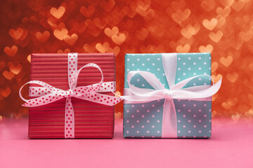 Blue and red gift boxes over heart shaped defocused lights. Valentine’s day greeting