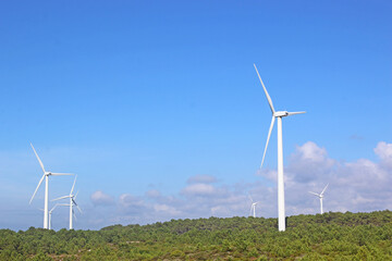 wind turbines against a blue sky	