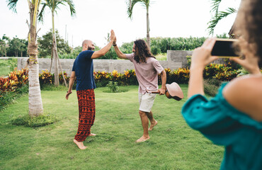 Cheerful multiethnic friends giving high five