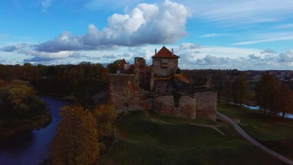 Wall Mural - Bauska Medieval Castle Ruins Complex and Park From Above Aerial Shot. Ruins of the Livonian Part of the Bauska Castle, Latvia in Autumn. Castle Was Built in the Middle of the 15th Century