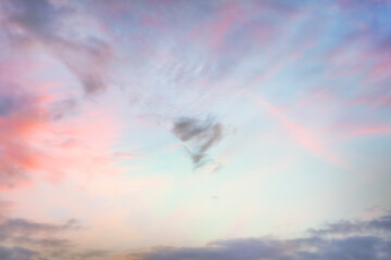 heart shaped cloud in the sky at sunset texture background.
