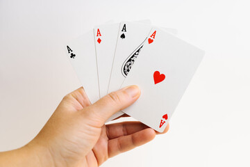 Poker aces in hand isolated on white background