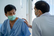 © ake - Caucasian medical doctor with patient infected from virus pandemic in hospital