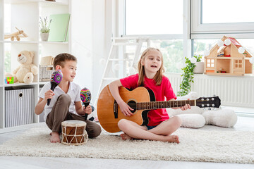 Wall Mural - Smiling kids playing on drum and guitar