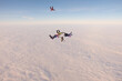 © Sky Antonio - Skydiving. A team of skydivers is doing a figure in the sky. Group jump.