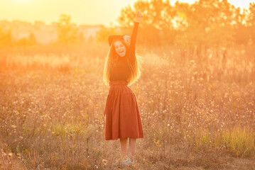 Happy young girl standing on autumn nature