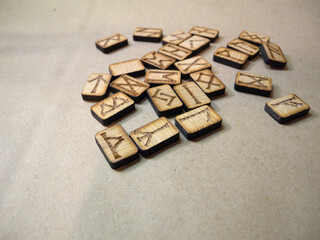 Homemade Scandinavian runes for divination. The runes say: wealth, fire, chaos, travel, knowledge, air, joy, duty, ice.