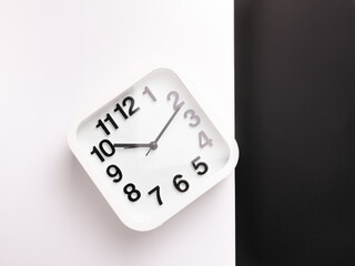 Top view image of square alarm clock isolated on white and black background. 