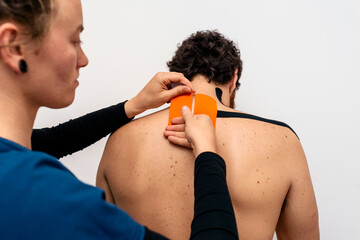 Wall Mural - Man receiving tape treatment in clinic.