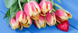 Fototapeta Tulipany - Bouquet of tulips on boards. Surprise for birthday, valentine or other occasion