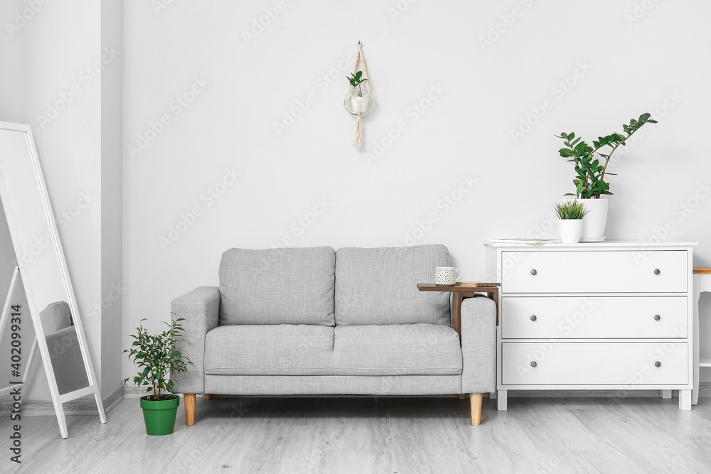 Armrest table on sofa in interior of room - obrazy, fototapety, plakaty 