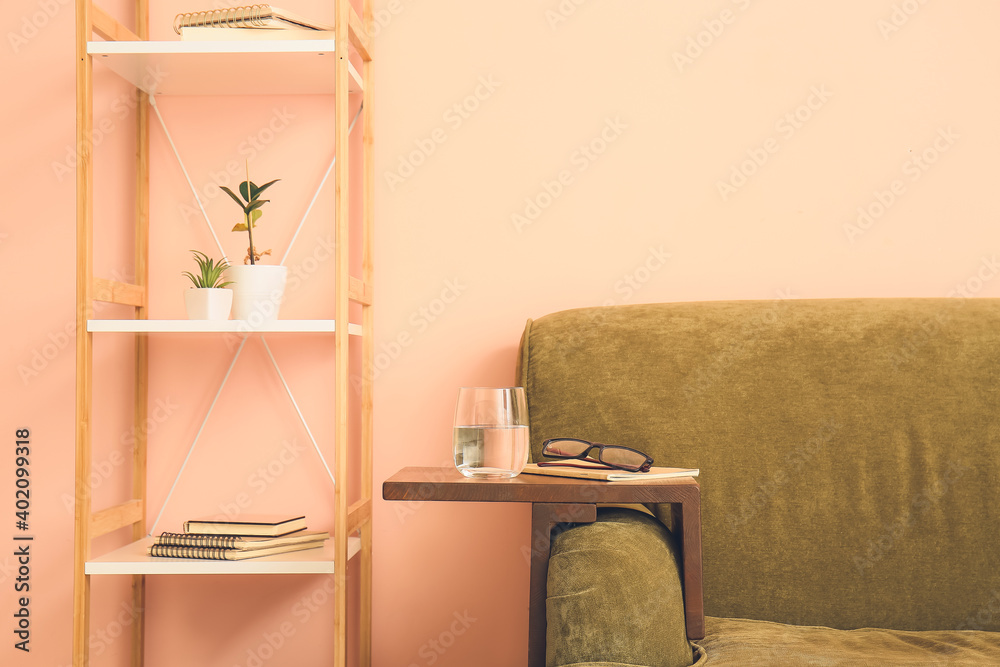 Armrest table on sofa in interior of room