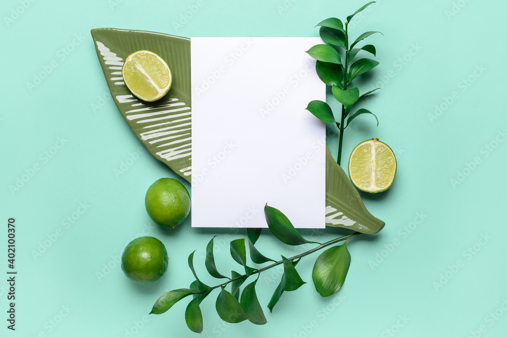 Composition with blank paper sheet and citruses on color background