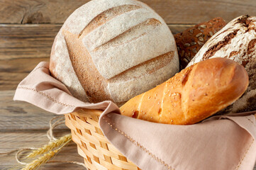 Wall Mural - Composition of various baked products in basket on rustic background. Homemade fresh pastry.