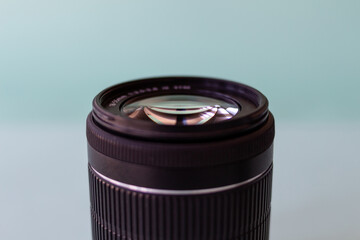 Sticker - A closeup shot of a camera lens isolated on light blue background