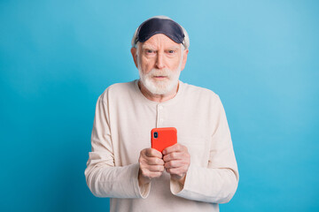 Wall Mural - Photo of retired man unhappy upset angry try to use cellphone negative isolated over blue color background