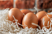 Close-up View Of Raw Chicken Eggs On Wooden Background. Fresh Farm Egg.