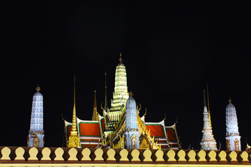 The beautiful pagodas stands majestically at night in Thai temple