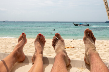 Sticker - Feet of a couple enjoying their holiday on a beach in Thailand