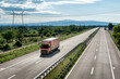 © Ivan - Highway transportation scene with Single Orange transportation trucks on a rural highway under a dramatic sky