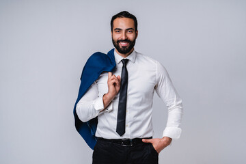 Wall Mural - Successful handsome young Middle Eastern man in formal outfit isolated over grey background
