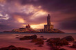 Kanyakumari - Vivekananda Rock Memorial Thiruvalluvar Statue in the evening with a colorful and cloudy sky background.