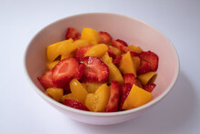 Pink Bowl With Chopped Strawberries And Peaches In Syrup