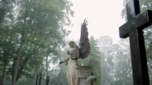 An Old Angel Statue At The Bernardine XIX Century Cemetery On A Foggy Day. 