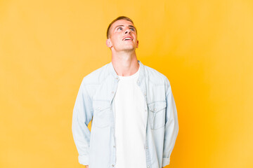 Young caucasian handsome man relaxed and happy laughing, neck stretched showing teeth.