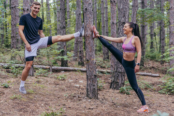 Fit male and female athletes running in nature. Nature and sports concept.