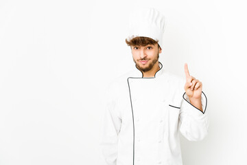 Young arab cook man showing number one with finger.