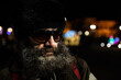 © Srdjan - Night close up portrait of old bearded homeless man with sunglasses standing on the street in the city in the cold winter time image with film grain