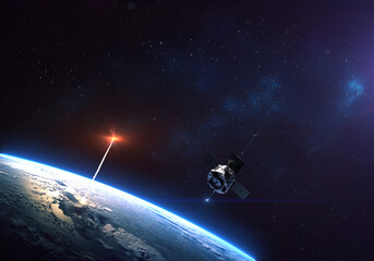 rocket launch from the earth planet through the clouds with a bright glow of the engine and a satell