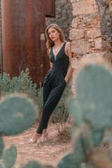 beautiful young woman whit a black jumpsuit in vintage place