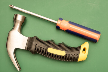 Standard workman tools isolated against a green cutting board.