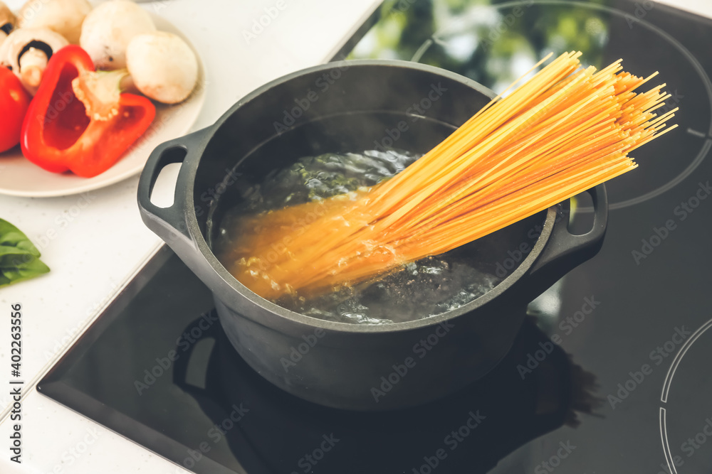 Pasta boiling in cooking pot on electric stove
