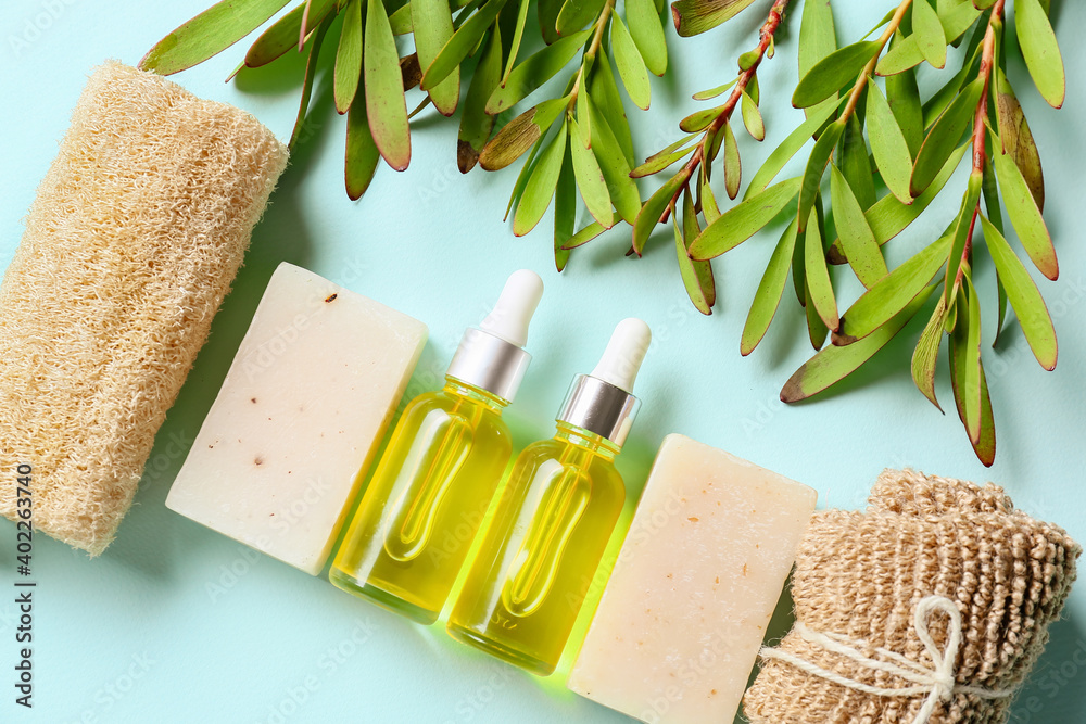 Bath supplies with essential oil on color background