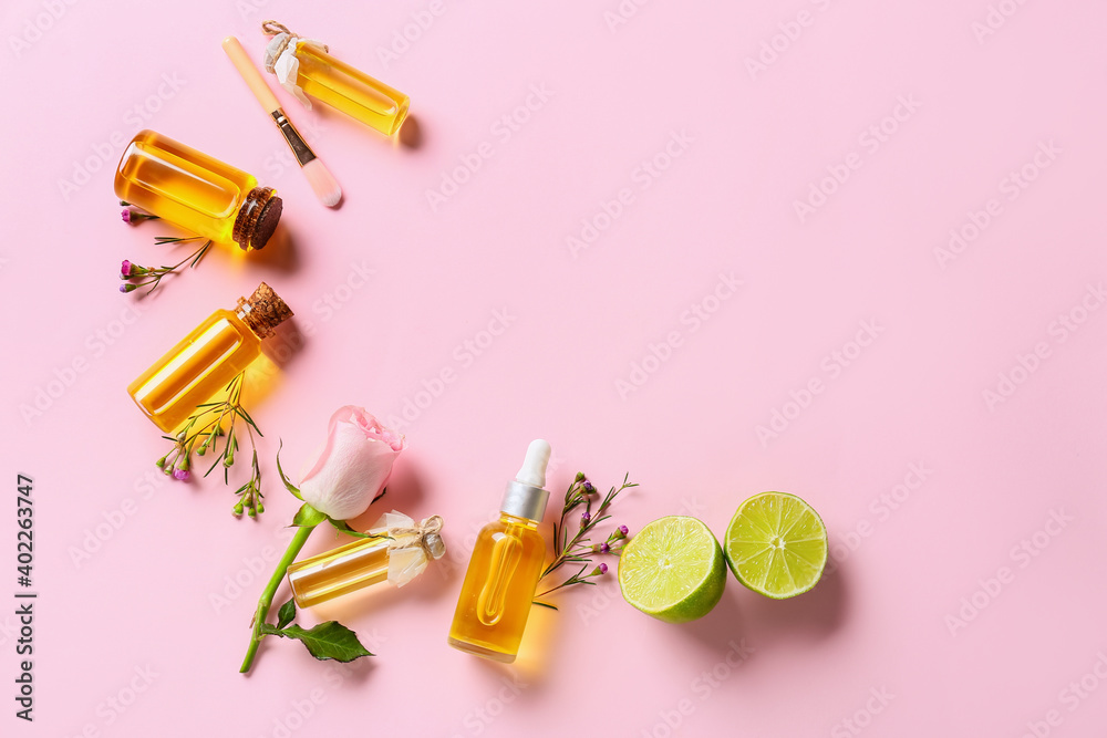 Bottles with floral essential oil on color background - obrazy, fototapety, plakaty 