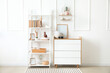 © Pixel-Shot - Interior of modern room with shelf unit and commode