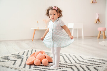 Poster - Cute baby girl in stylish dress at home