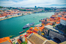 Aerial Panoramic View Of Porto Oporto City Historical Centre With Douro River With Boats Between Ribeira District And Vila Nova De Gaia Town, Norte Or Northern Portugal