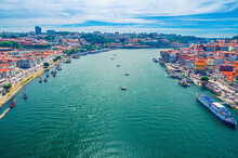 Aerial Panoramic View Of Porto Oporto City Historical Centre With Douro River With Boats Between Ribeira District And Vila Nova De Gaia Town, Norte Or Northern Portugal