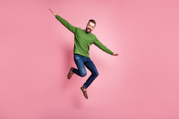 Wall Mural - Full length body size view of attractive cheerful mature guy jumping having fun celebrating isolated over pink pastel color background