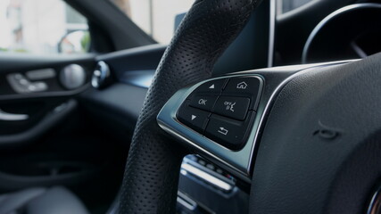 Controls on the steering wheel of a right hand drive luxury car