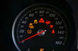 © Ethan L - Close up of speedometer dial with warning lights on a car