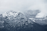 Fototapeta Na ścianę - View from above, stunning panoramic view of a snow capped mountain range during a cloudy day. Italy